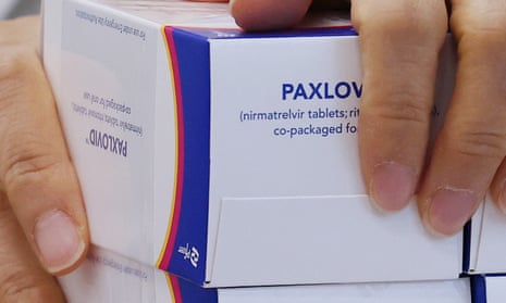 A pharmacist checks boxes containing Paxlovid
