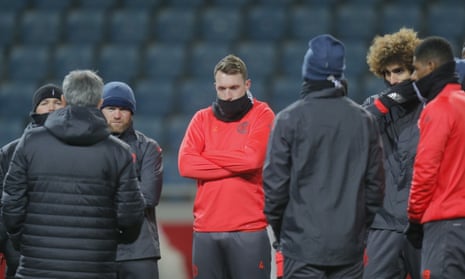 Manchester United players wrap up warm to listen to José Mourinho, second left, during a training session before their final Europa League tie against Zorya.