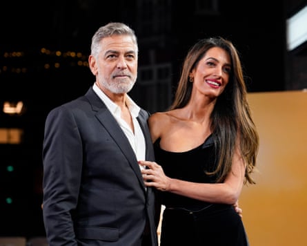 George Clooney and Amal Clooney pose for a photo before a screening of the film, The Boys in the Boat, in London in 2023