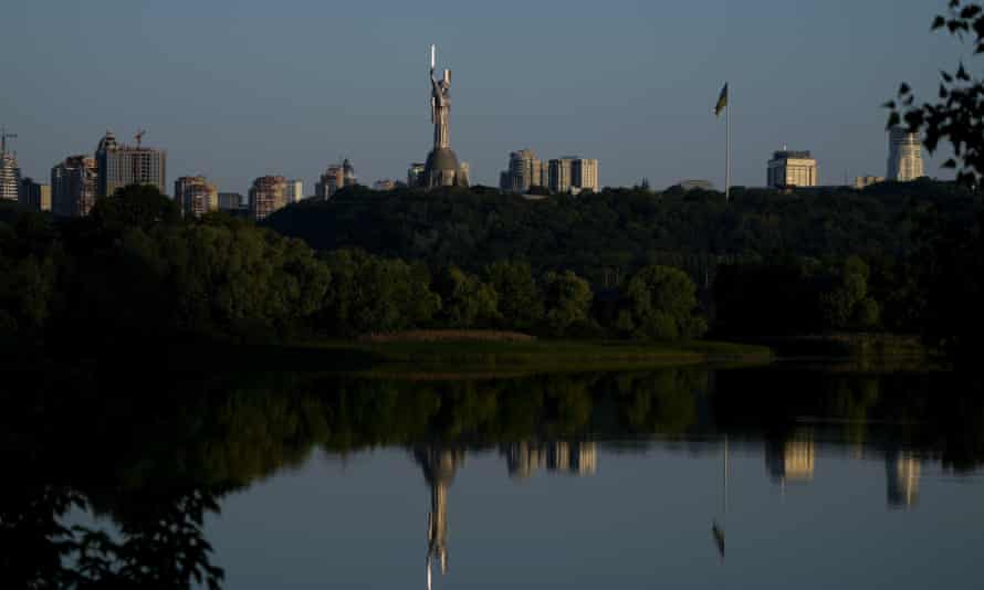The Motherland Monument is reflected on the Dnieper River in Kyiv, Ukraine.