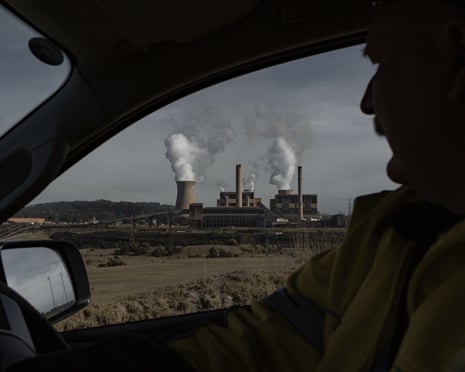 A worker drives past Yallourn power station in Victoria, Australia