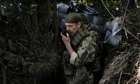 A Ukrainian serviceman speaks on a radio at a front line in the eastern Ukrainian region of Donbas on June 10, 2022.