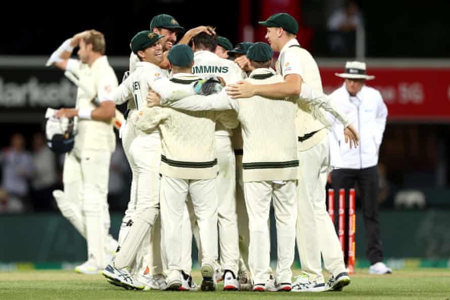 Cummins celebrates the wicket of Robinson.