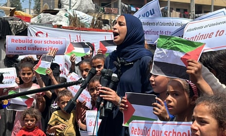 Palestinian children in the Gaza Strip hold a press conference and event in the courtyard of a school turned into a shelter in the southern city of Rafah.