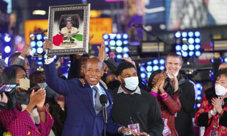 Eric Adams holds up a framed photo of his mother, at his swearing-in as New York mayor in Times Square.