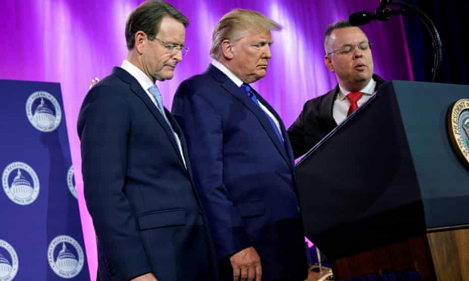 Donald Trump prays between Tony Perkins, the president of the Family Research Council, and Pastor Andrew Brunson.