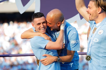 Phil Foden and Pep Guardiola embrace.