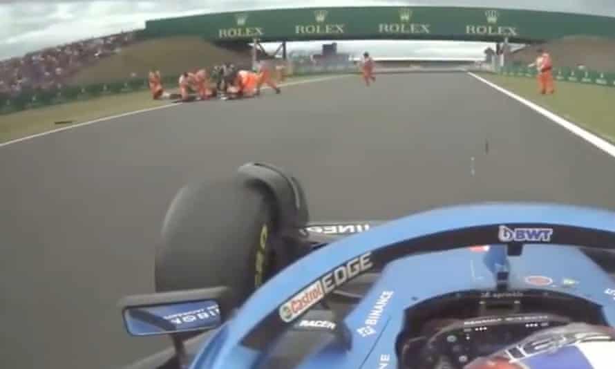 Protesters on the Silverstone track are moved by marshals.