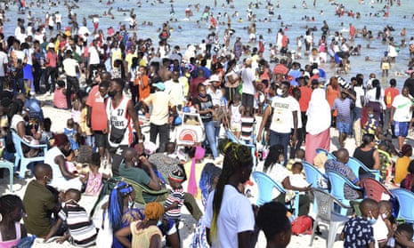 Hundreds of people sitting, standing or bathing at the  Jomo Kenyatta public beach in Mombasa, Kenya