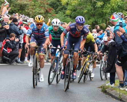 Romain Grégoire (centre, green) shadows challenger Remco Evenepoel (left) up Caerphilly mountain