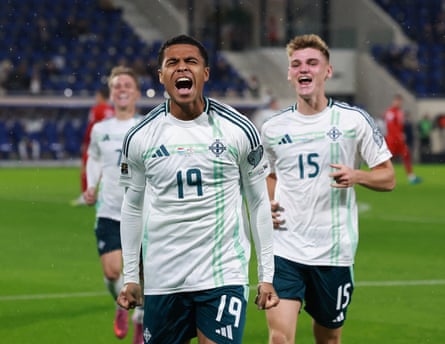 Shea Charles celebrates scoring Northern Ireland’s 2nd extremity pinch chap scorer Justin Devenny.