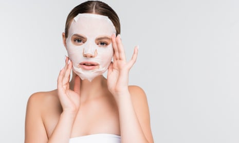 Woman with a moisturising sheet mask on her face