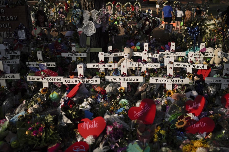 Flowers are piled around crosses with the names of the victims killed in last week’s school shooting as people visit a memorial at Robb Elementary School to pay their respects, Tuesday, May 31, 2022, in Uvalde, Texas. (AP Photo/Jae C. Hong)