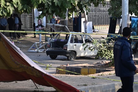 Police inspect the cordoned-off site, a day after the suicide bombing in Islamabad