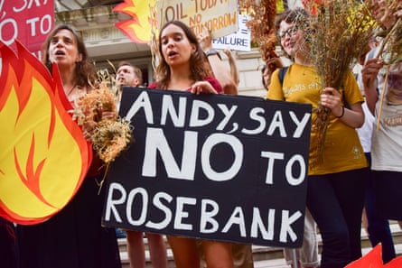 A protester holds a message for Prime Minister Andy Burnham during a protest against Rosebank by the climate action group Fossil Free London outside the Treasury in Westminster
