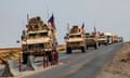 A convoy of US military vehicles, arriving from northern Iraq, drives along a road in the countryside of Syria’s north-eastern city of Qamishli on 26 October 2019.