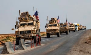 A convoy of US military vehicles, arriving from northern Iraq, drives along a road in the countryside of Syria’s north-eastern city of Qamishli on 26 October 2019. 5472.jpg?width=300&quality=85&auto=forma