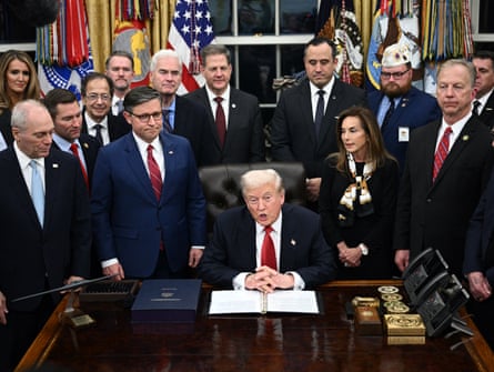 President Donald Trump speaks while signing the bill package to open the federal government in the Oval Office. The clock is visible on the desk.