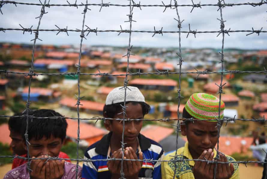 Rohingya refugees perform prayers on the anniversary of a military crackdown that prompted a massive exodus of people from Myanmar.