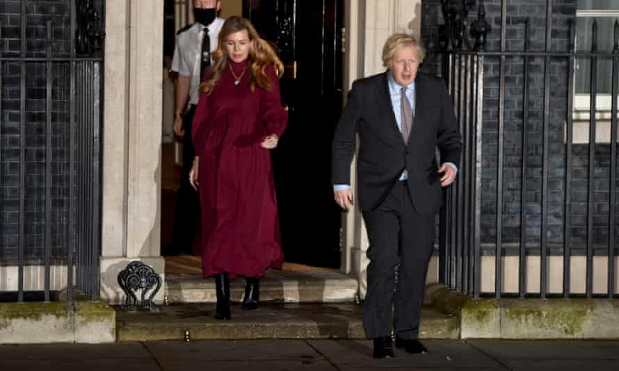 Boris Johnson and Carrie Symonds leave 10 Downing Street in February 2021 to take part in a national applause for Captain Sir Tom Moore, after his death, and NHS staff.