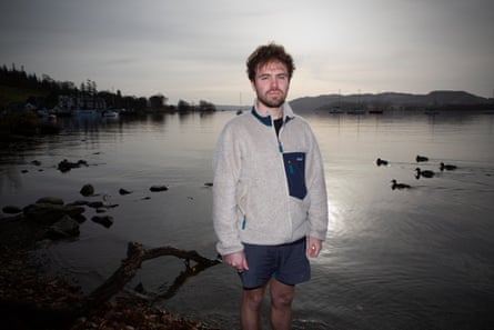Staniek stands by the lake with ducks swimming nearby