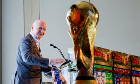 Fifa’s president, Gianni Infantino, beside the World Cup trophy