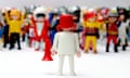 playmobil man wearing bucket on head and loudhailer addressing crowd of figures