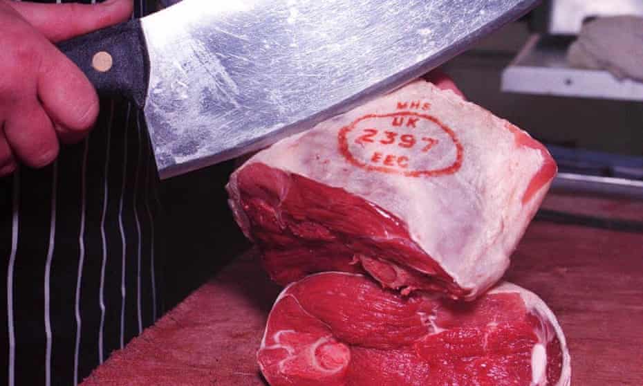 A joint of lamb being prepared in a butchers
