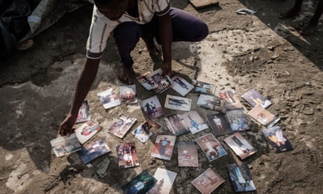 Joaquin Joao Chidja, 16, dries his family photos on the roof of a commercial building in Buzi, Mozambique.