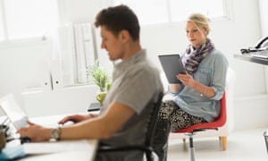 A man and a woman working in an office together