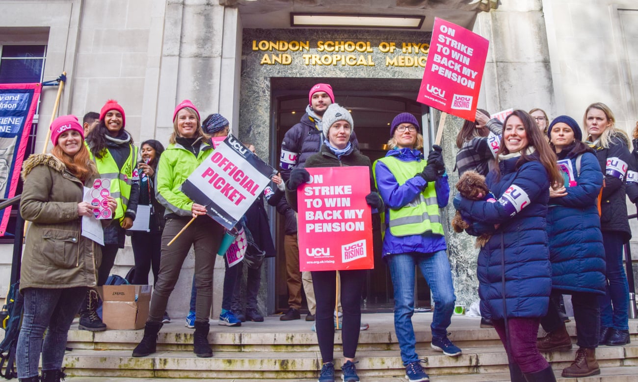  University and College Union (UCU) members hold placards which state 'On strike to win back my pension' during the demonstration at the picket line outside the London School of Hygiene and Tropical Medicine.