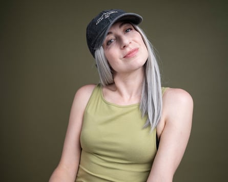 Leah in long grey wig and baseball hat