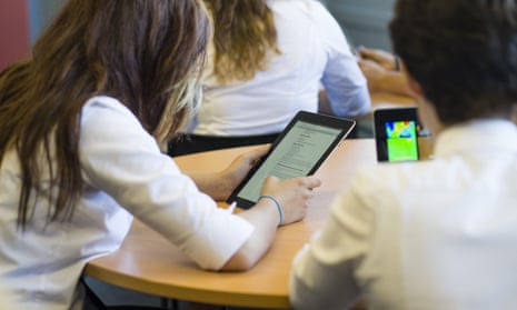 Schoolgirls using iPads during a lesson at a comprehensive secondary school