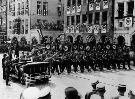 Adolf Hitler saluting a march-past at the Nazis’ 1935 rally in Nuremberg.