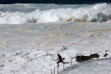 A surfer jumps to catch a wave on Bronte beach in Sydney