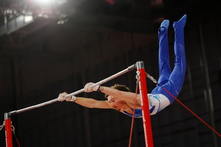 Reuben Ward performs on the high bar.