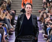 Olivia Colman walks the Miu Miu runway in a black leather suit