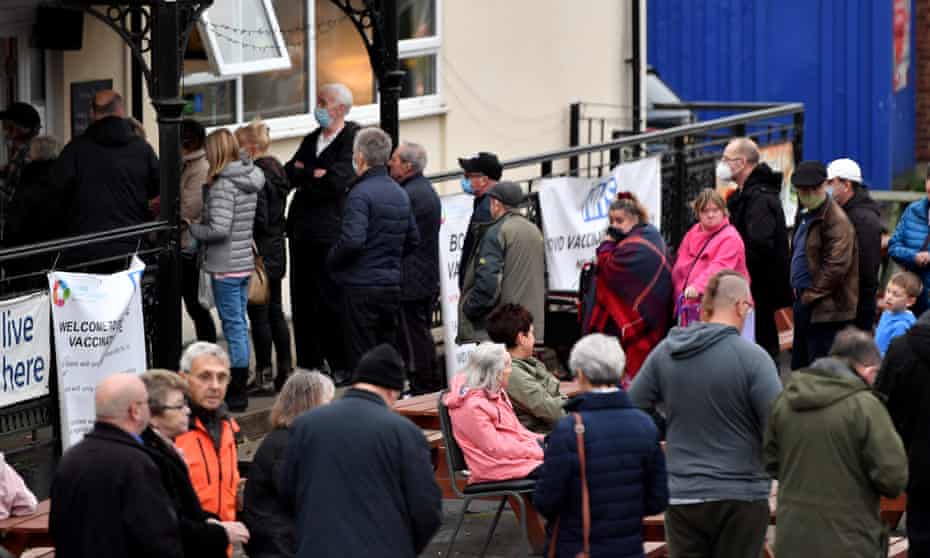 People queue outside the New Stalybridge Labour Club in Greater Manchester