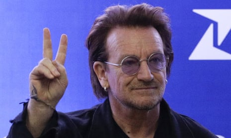 Bono making a peace sign