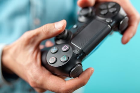 Male hands holding a PS4 controller