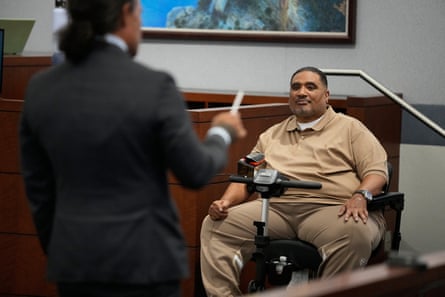 a man testifies during a trial as he is questioned