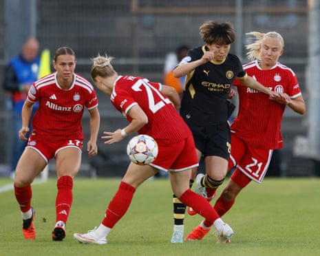 Manchester City's Aoba Fujino goes past the challenge from Bayern Munich's Franziska Kett (second left) and Pernille Harder (right) as Klara Buhl (left) looks on.