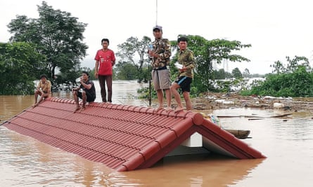 Villagers are stranded on a roof of a house