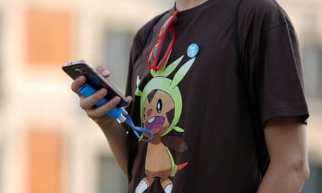 A person plays the augmented reality mobile game Pokémon Go at Puerta del Sol square in Madrid, Spain.
