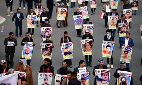 Demonstrators in Baghdad carry the pictures of the victims of protests