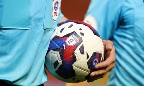 A referee holds a SkyBet-branded EFL ball.