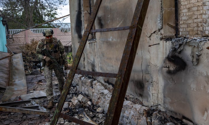 Ukrainian Territorial Defense soldiers inspect a damaged home while on patrol near the frontline on May 22, 2022 near Ruski Tyshky, Ukraine. Russian forces had occupied Ruski Tyshky for two months before being pushed back by Ukrainian troops three weeks ago. Although Russian forces have retreated from many areas around Kharkiv, some units have dug in north of the city and continue to trade shellfire with the Ukrainians.