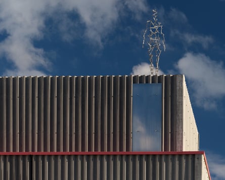 A spindly metal human figure sculpture tops the Yard Theatre building in Hackney Wick