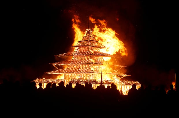 Participants watch the Temple Project burn on Sunday night.