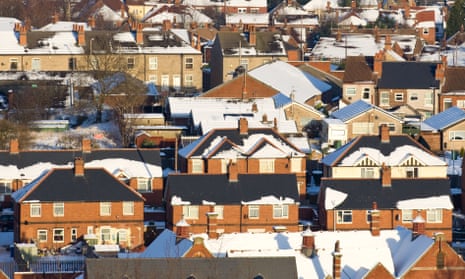 UK homes in winter with snow on their roofs